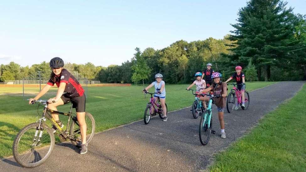 Maya Healey, far left, during a bike clinic she organized for girls as part of a Girl Scouts project to earn her Silver Award. She also did trail work on the Schenectady Central Park as part of the project. (Photo by Theresa Healey)