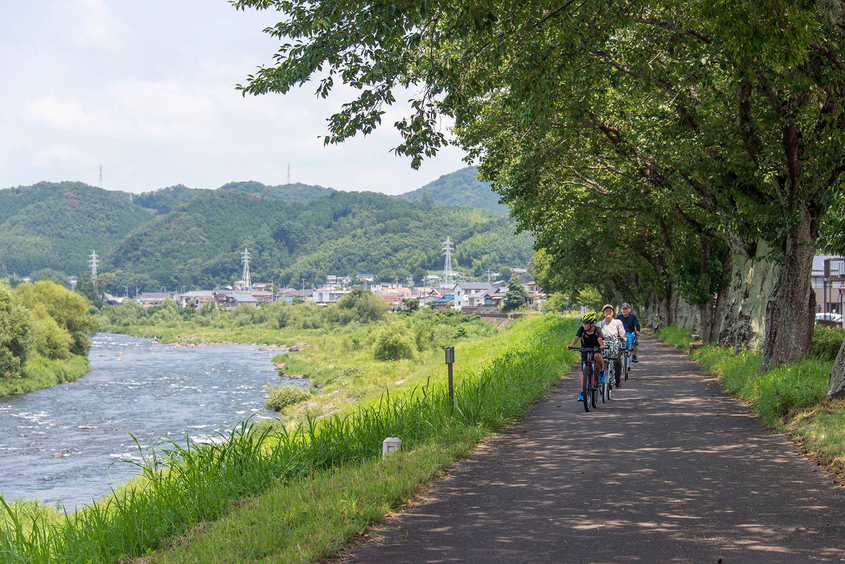 Cyclists ride along the Kano River in Izu City, Shizuoka Prefecture, in August 2019. | ROB GILHOOLY