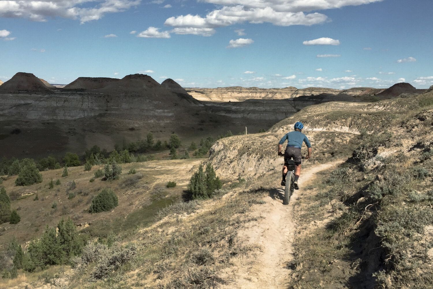 man mountain bikes in north dakota on the maah daah hey trail