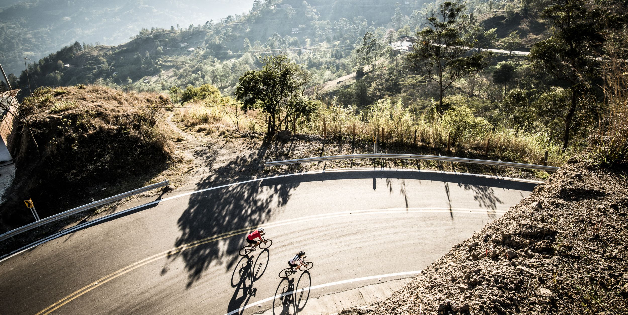 two riders prepare for a descent in the eastern range of the colombian andes mountains